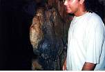 GuideInsideCaveStandingBesideBuffaloHeadRockFormation.jpg